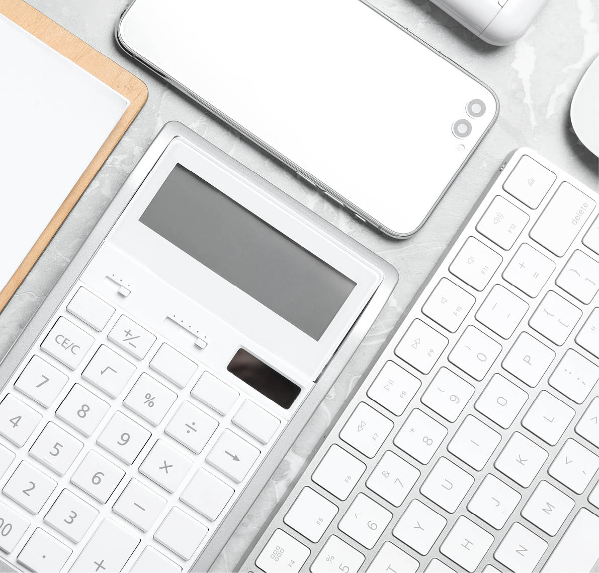 Calculator, smartphone and keyboard on grey table, flat lay  Tax accounting