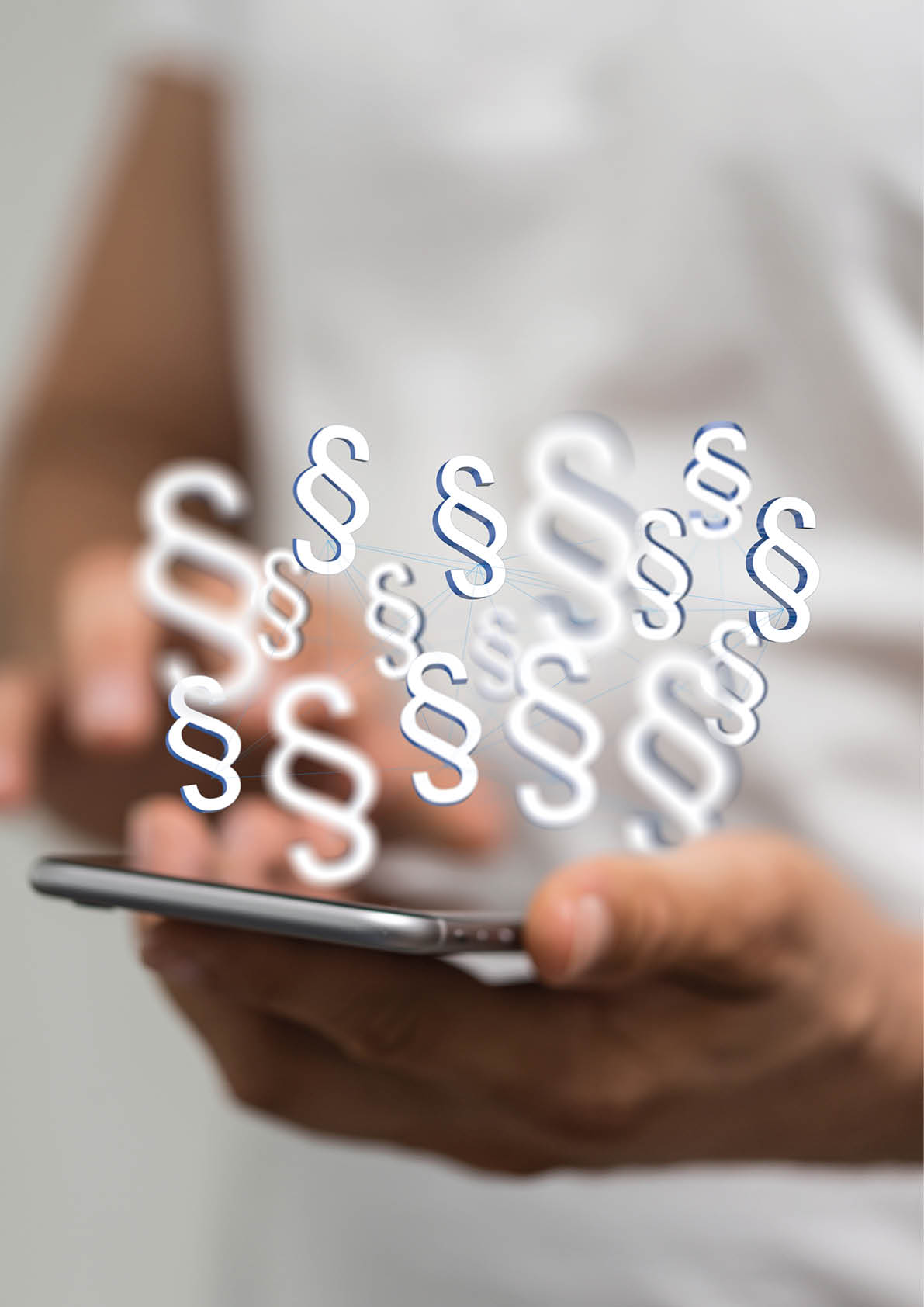A vertical shot of a human hand holding the virtual projections of digital paragraph law symbols