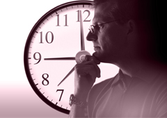 Un hombre pensando al lado de un reloj